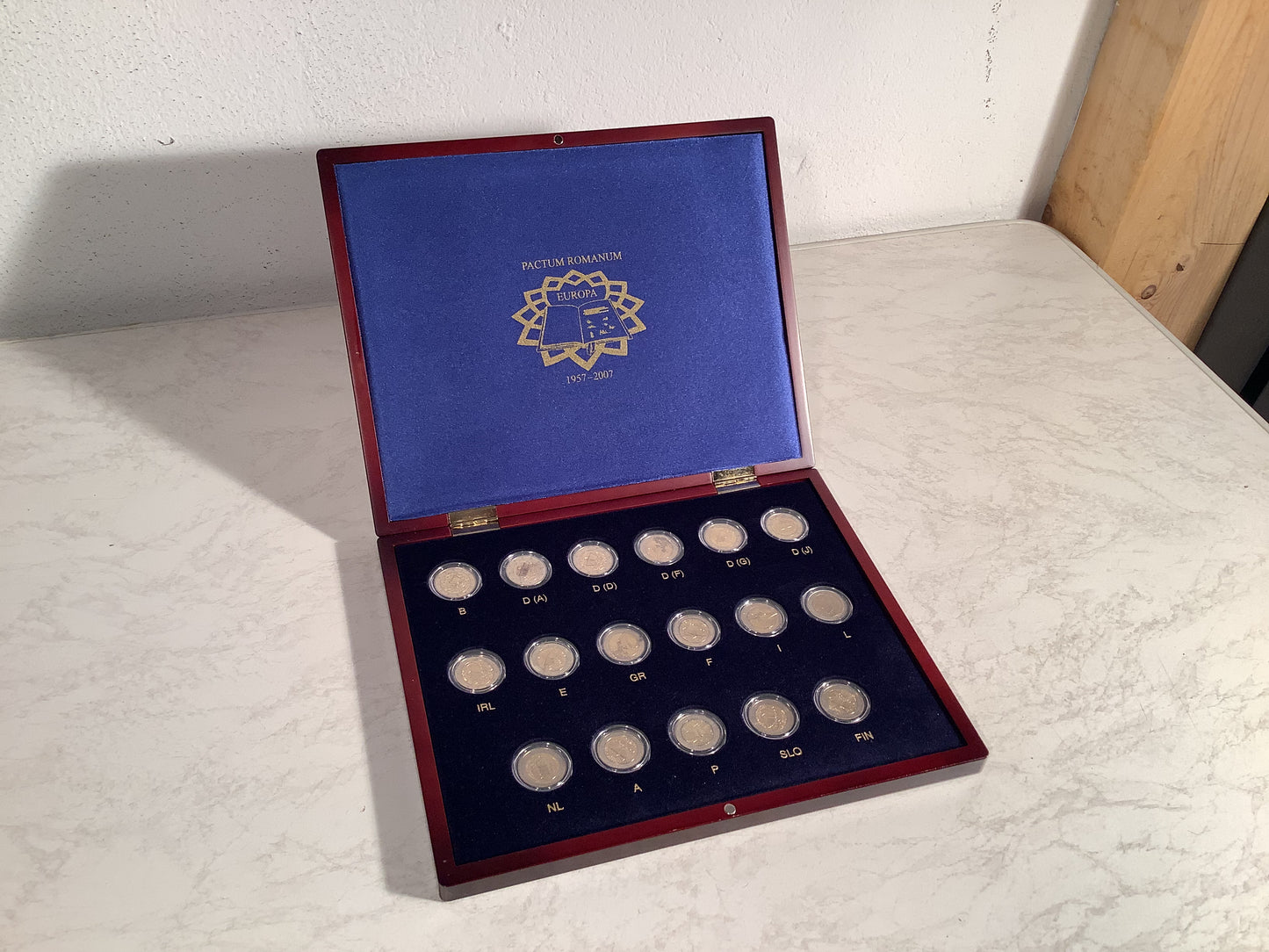 European €2 coin collection in a wooden box