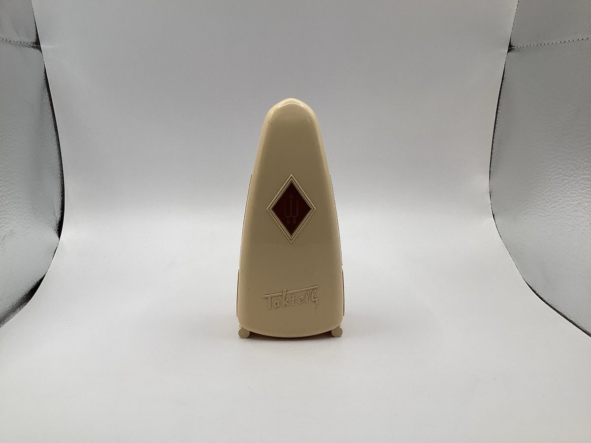 Wittner Taktell Piccolo Metronom, cremefarbenes Gehäuse mit Taktell-Schriftzug, Vorderansicht